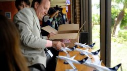 "In this July 15, 2011 photo, Michael Jones, the business development manager at Brownsville South Padre Island International Airport in in Brownsville, Texas, lays out a series of model Aeromexico planes to be given to dignitaries upon the arrival of Aeromexico's first direct flight to the airport from Monterrey, Mexico. (AP Photo/The Brownsville Herald, Paul Chouy)"
